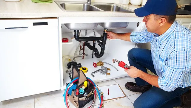 One of our plumbers fixing a sink